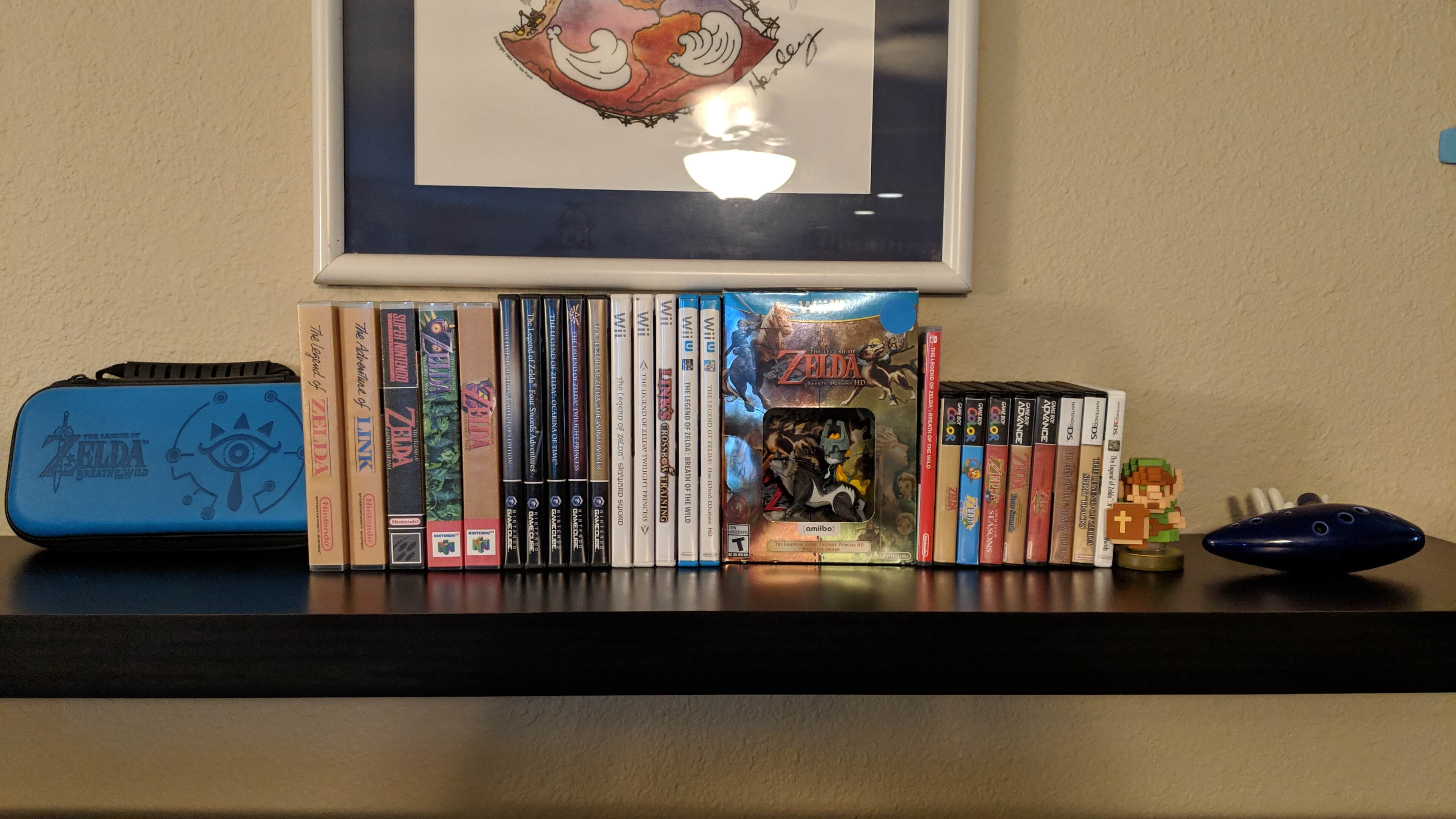 picture of my Legend of Zelda games and collectibles shelf