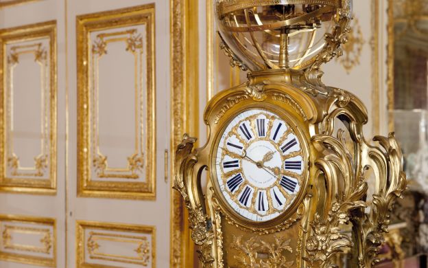Opulent golden watch: Timeless elegance captured within Versailles Palace's walls, a magnificent display of grandeur.