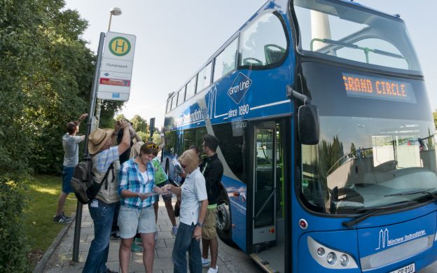 Excited passengers eager to board the GrayLine Munich Hop-on, Hop-off Bus, ready to begin their memorable exploration of the city.