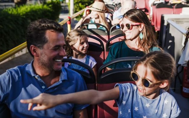A father and daughter share joyous memories aboard the City Sightseeing Thessaloniki Hop-On, Hop-Off bus, creating cherished memories.