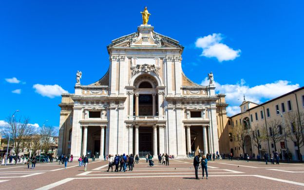 A stunning photo of Papal Basilica of Saint Mary, a beautiful church nestled in the serene landscape of Assisi, Italy.