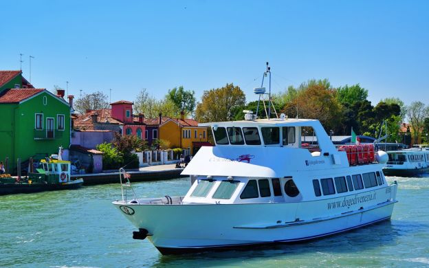 Daytime, cruise ships gracefully glide along Murano and Burano's canals, enveloped by their iconic charm and vibrant ambiance.