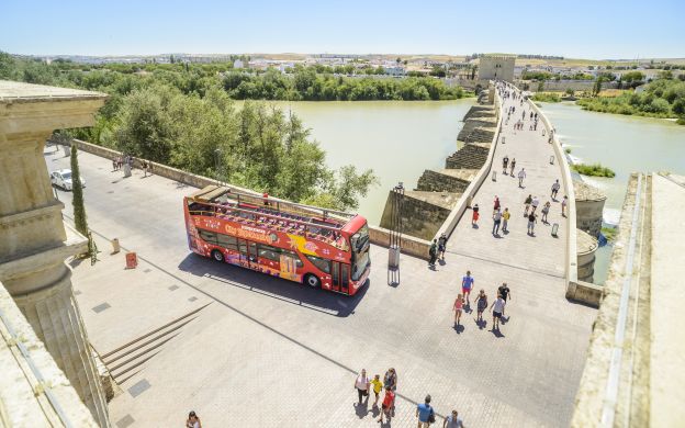 City sightseeing bus in Cordoba: Aerial view of the bus parked, ready for passengers to explore architectural wonders and return for a comfortable ride.