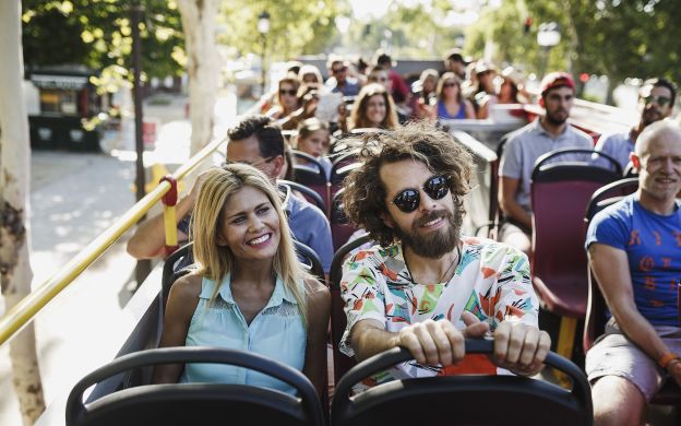Delighted passengers in Toledo enjoy the scenic Hop-on Hop-off bus ride, exploring the city's attractions and soaking in the vibrant atmosphere.