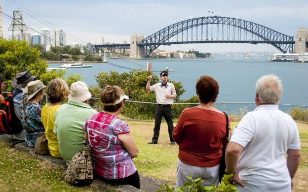 With the iconic Sydney Harbour Bridge as a backdrop, the enthusiastic guide imparts essential instructions for an unforgettable Sydney tour.