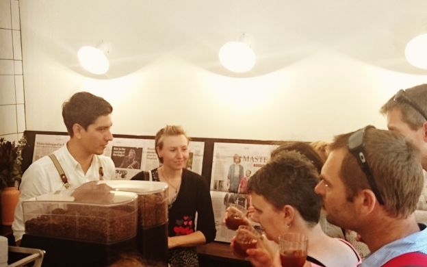 Savoring welcome drinks at a Melbourne cafe, tourists bond over laughter and joy, creating cherished memories together.