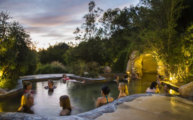 Travelers unwind at Peninsula Hot Springs, enjoying serene relaxation and embracing the tranquil ambiance of this blissful destination.