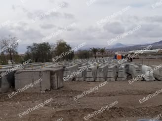 30,000LF of Used F-Rail Barrier in rows in a yard