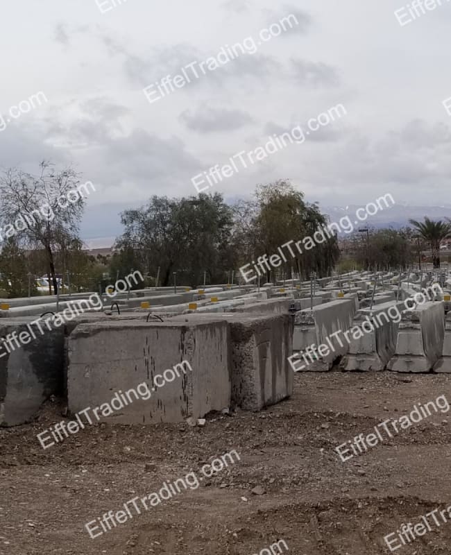 30,000LF of Used F-Rail Barrier in rows in a yard