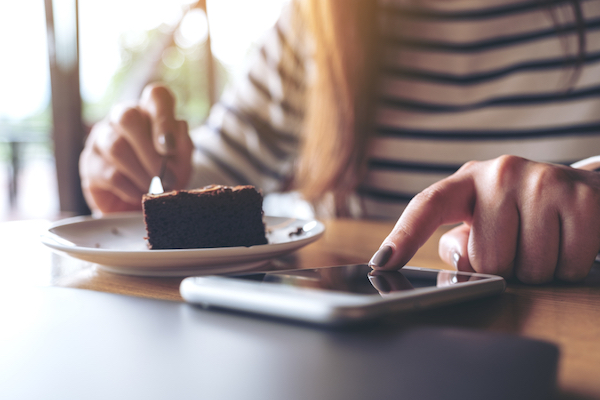 Woman snacking on a brownie during 10000 steps challenge.