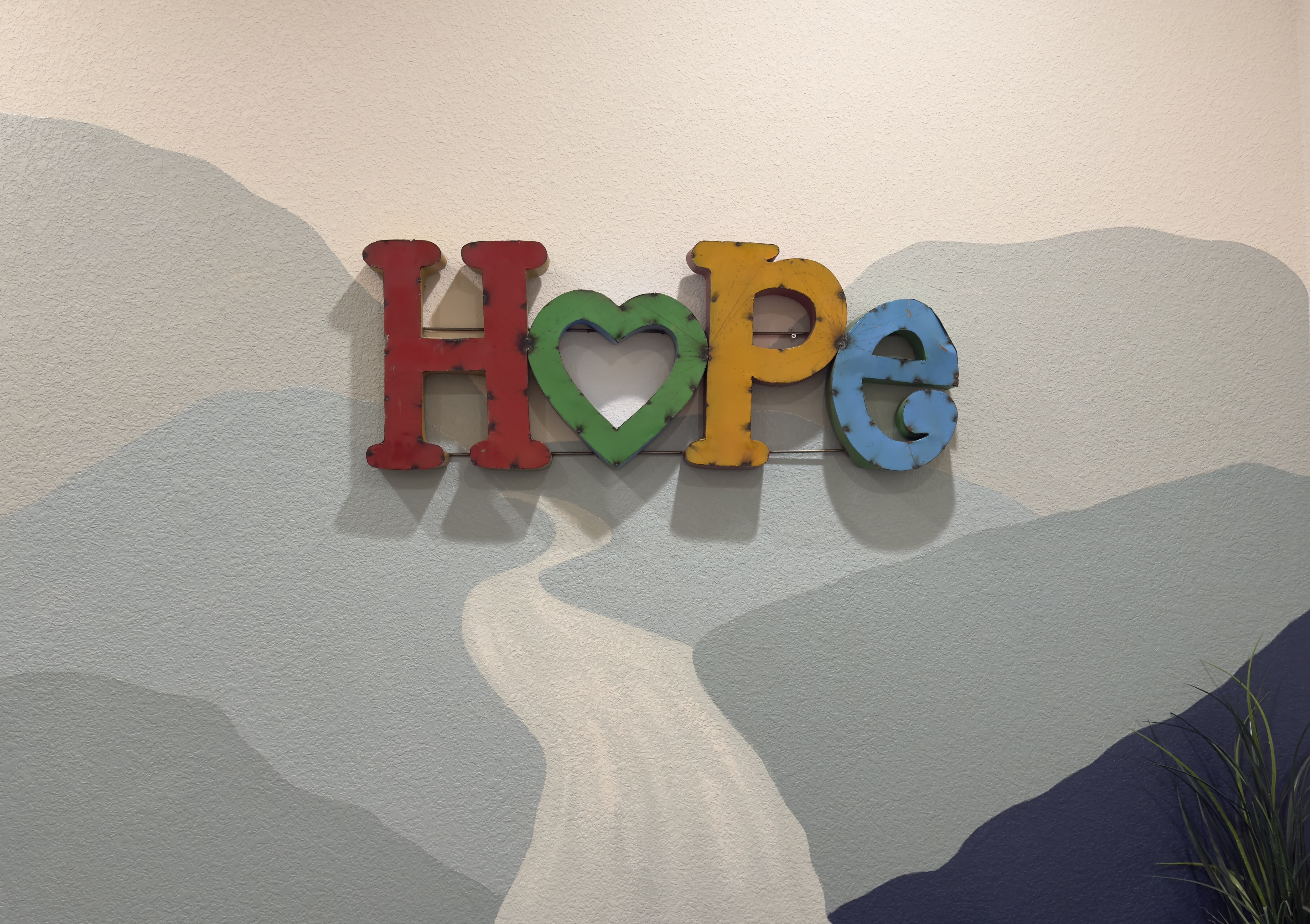 Hope artwork with a mountain background in our Round Rock office