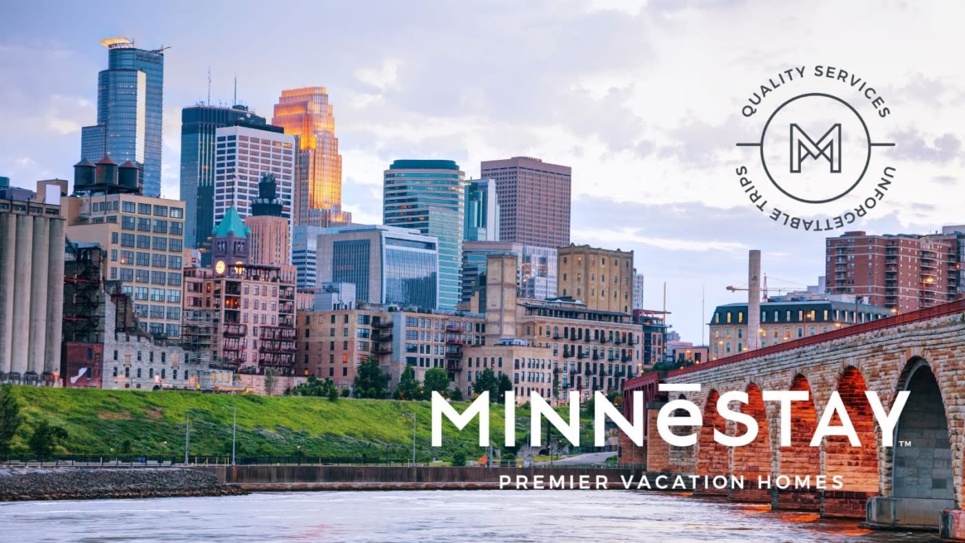 View of Downtown Minneapolis with the MINNeSTAY logo bottom right.
