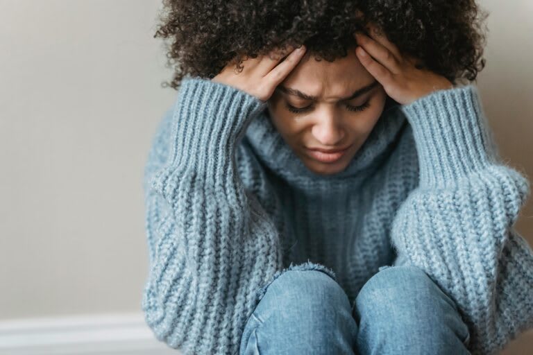 A person overwhelmed by emotion in a moment of distress