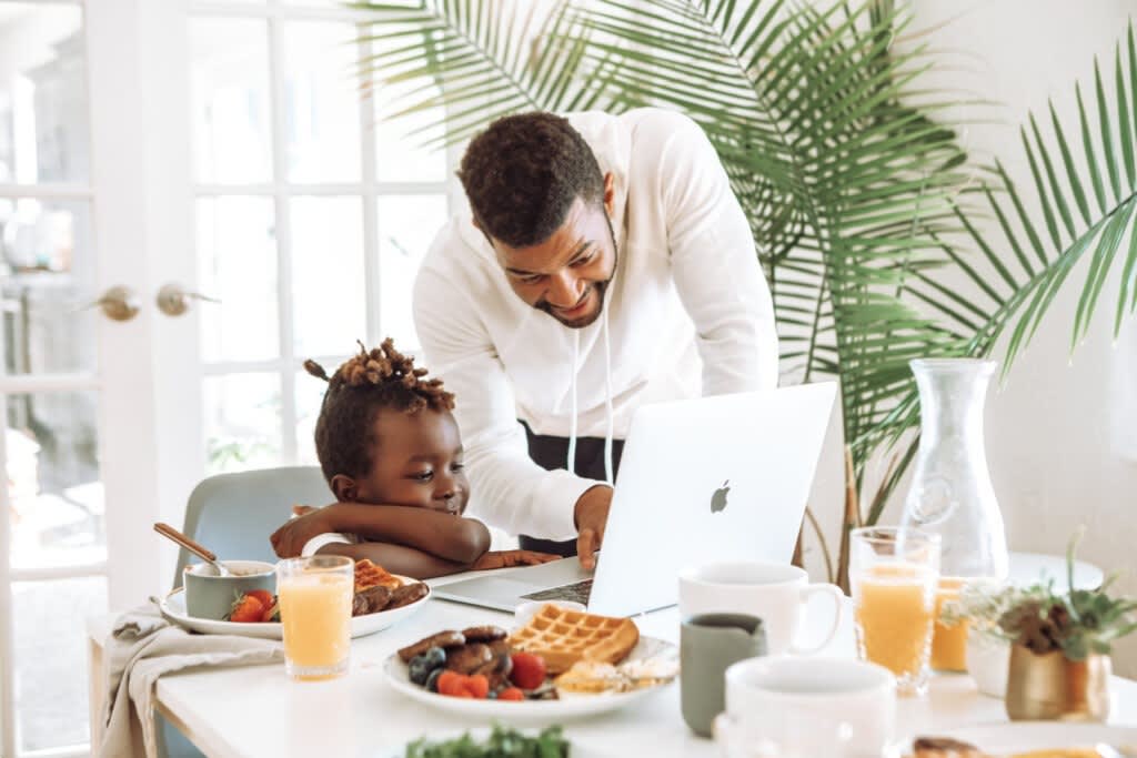 A parent and child sharing breakfast together