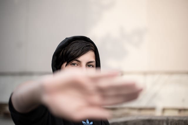 A person in motion with their face hidden