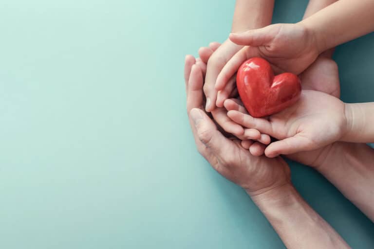 Hands joined together forming a heart shape