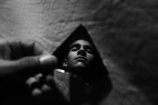 A person's reflection captured in shadows