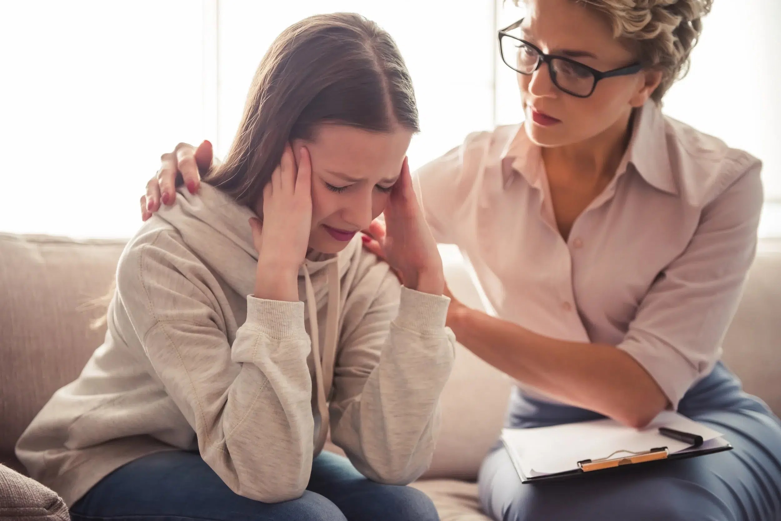 A teen in a supportive counseling moment with a therapist