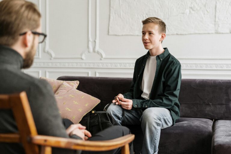Two people in a thoughtful conversation in a cozy setting