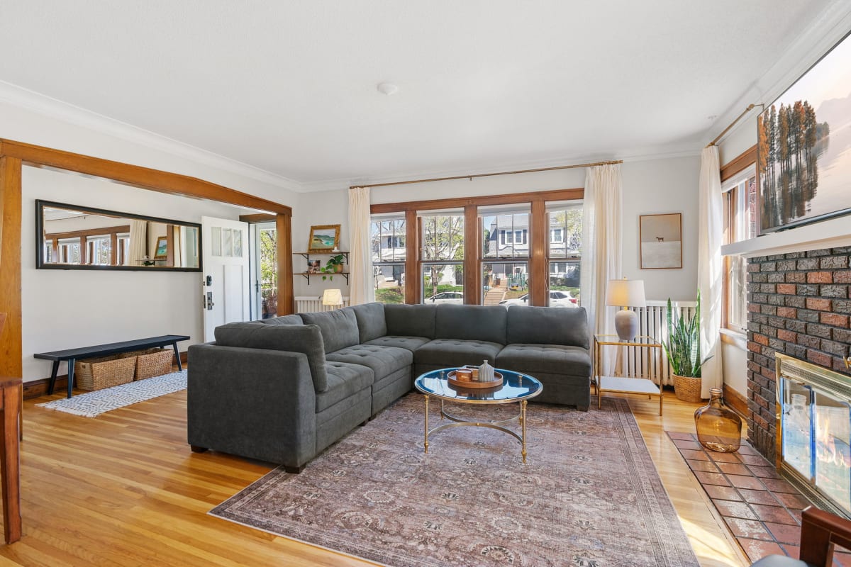 A cozy and inviting living room featuring a sectional sofa and bright natural light.