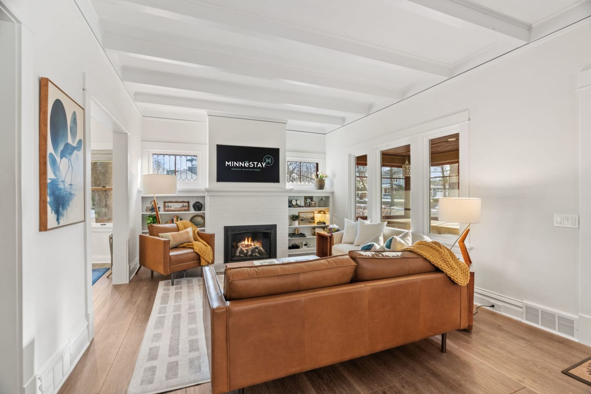Relax in your stylish living room with rich leather seating, cozy fireplace, and thoughtful details creating the perfect atmosphere for unwinding.