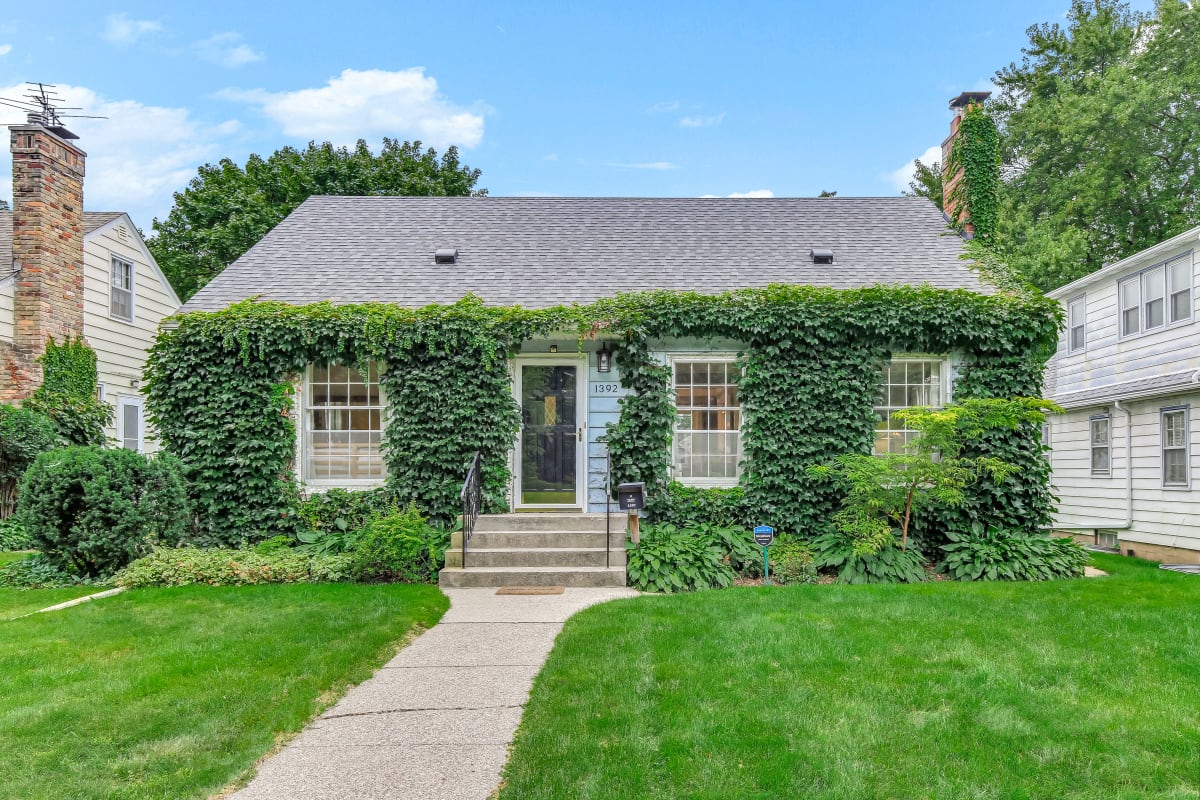 Charming ivy-covered bungalow in a serene suburban setting.