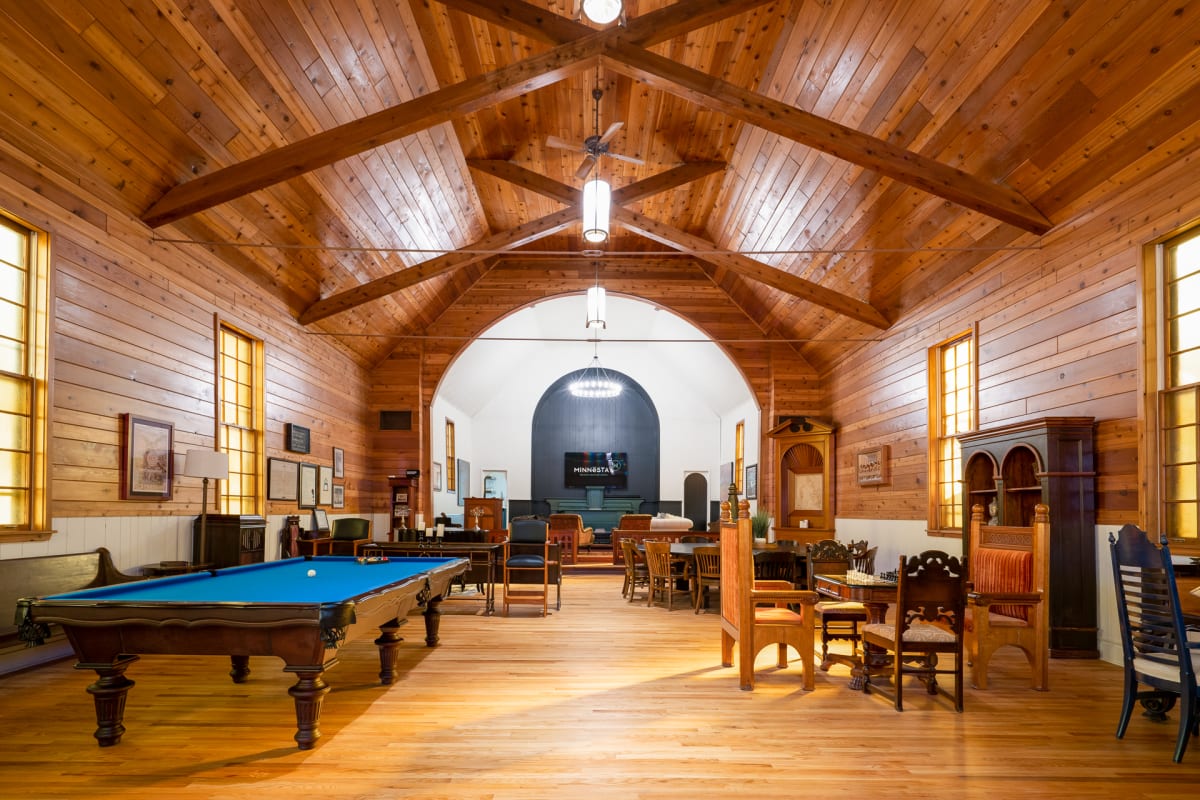 A cozy game room featuring a billiards table and vintage furniture.