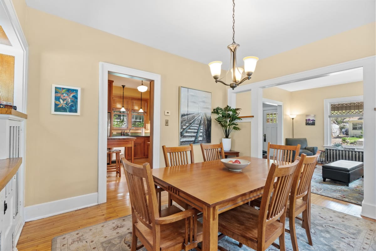 Warm and inviting dining area with a view into the kitchen and living room.