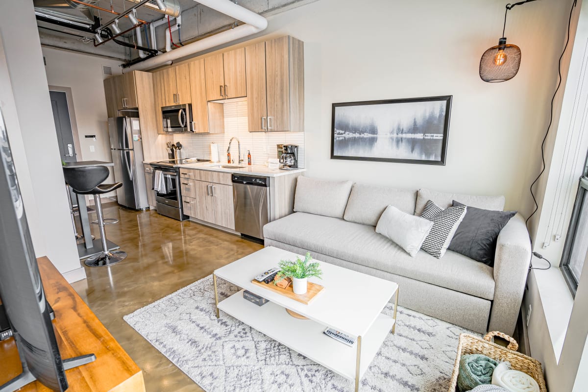 A chic and modern studio apartment with an open kitchen and cozy living area.