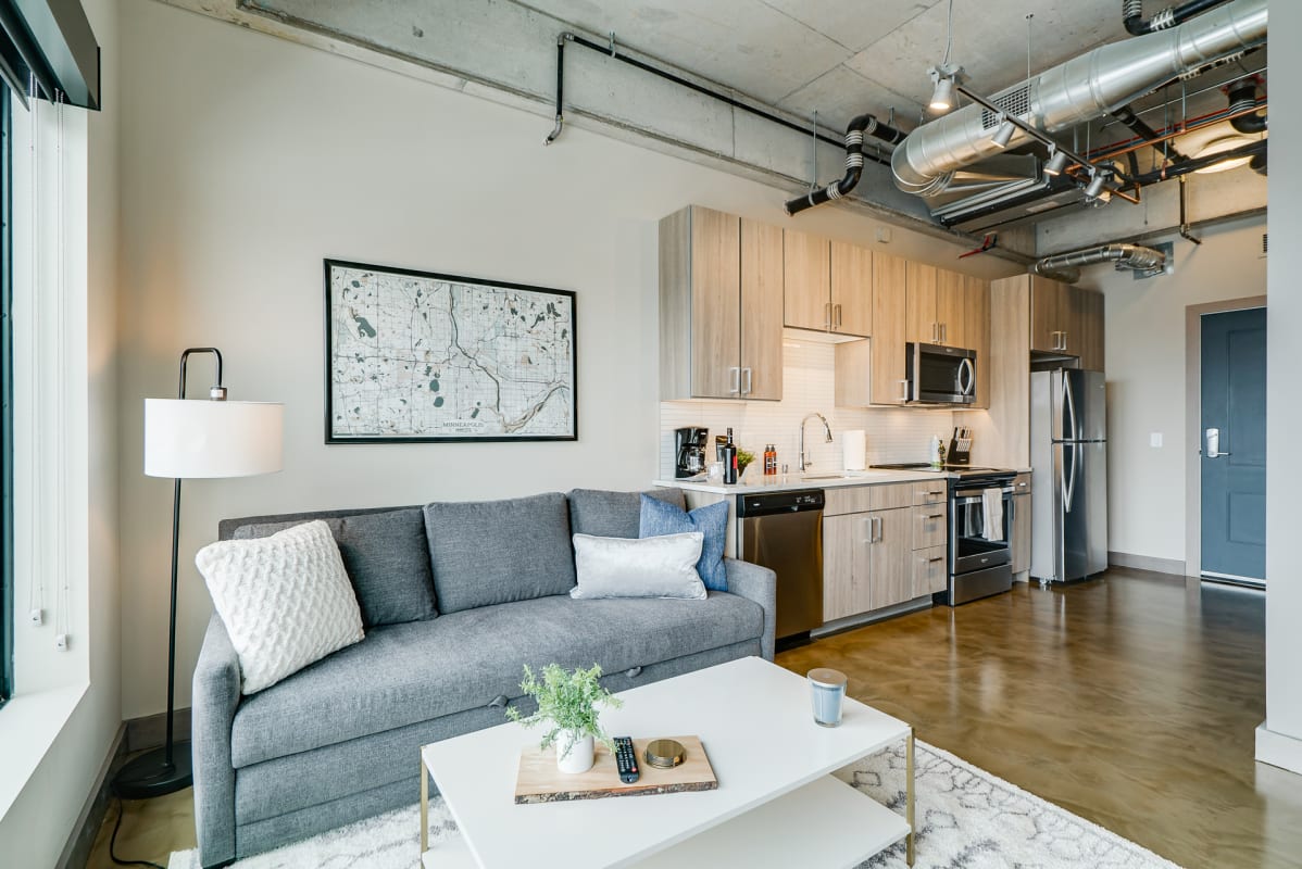 Modern apartment interior with a cozy living area and a functional kitchen.