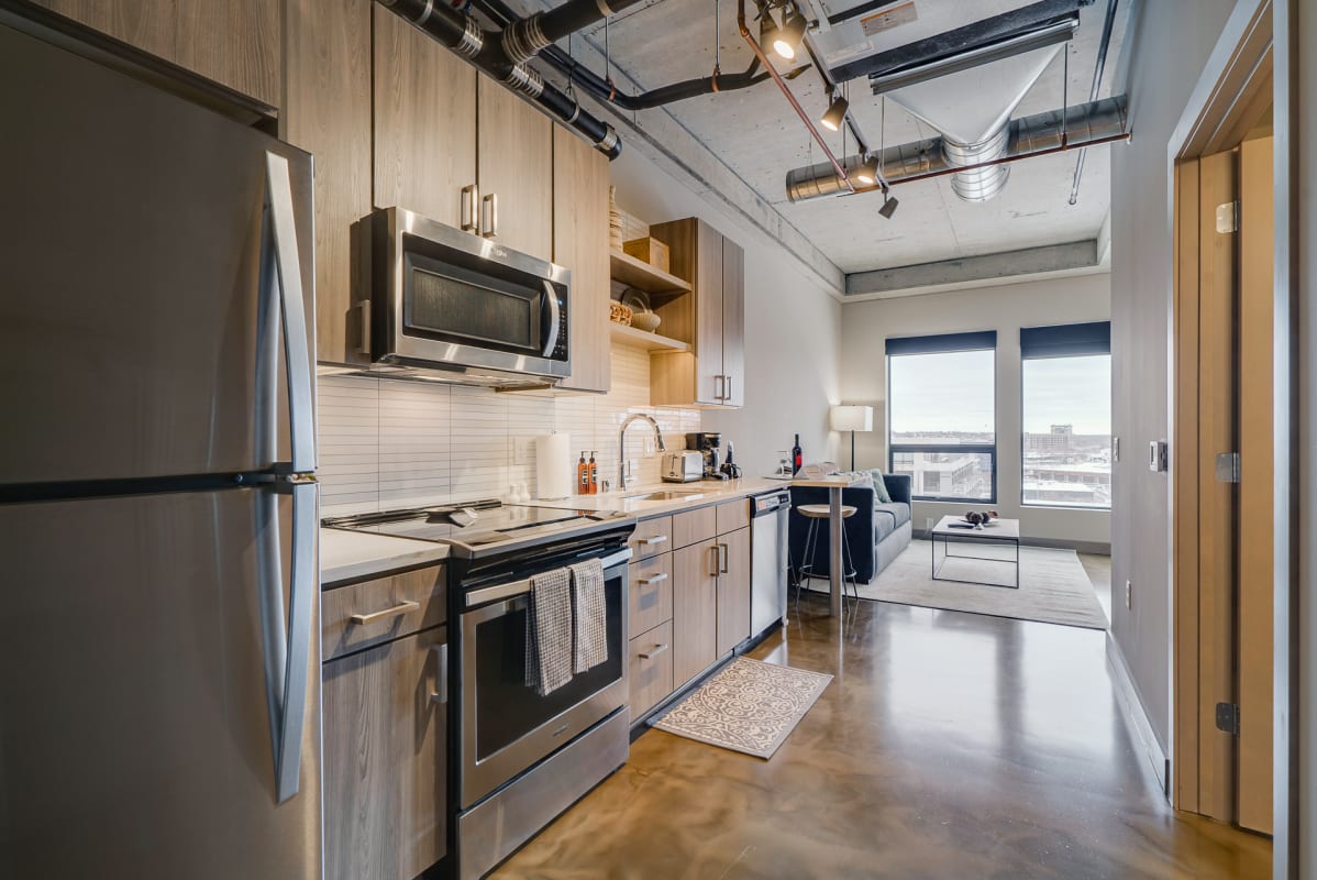 A modern kitchen and living area in an apartment with stylish decor.
