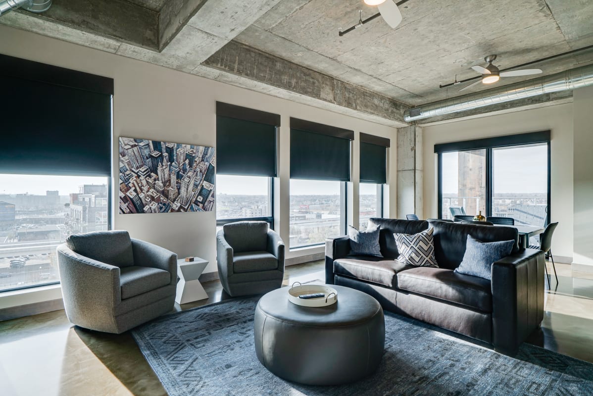 A modern living room with city views and contemporary furnishings.