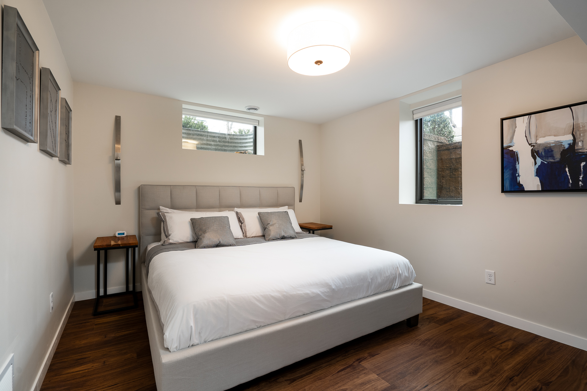 A modern and minimalist bedroom featuring a queen-sized bed and contemporary decor.