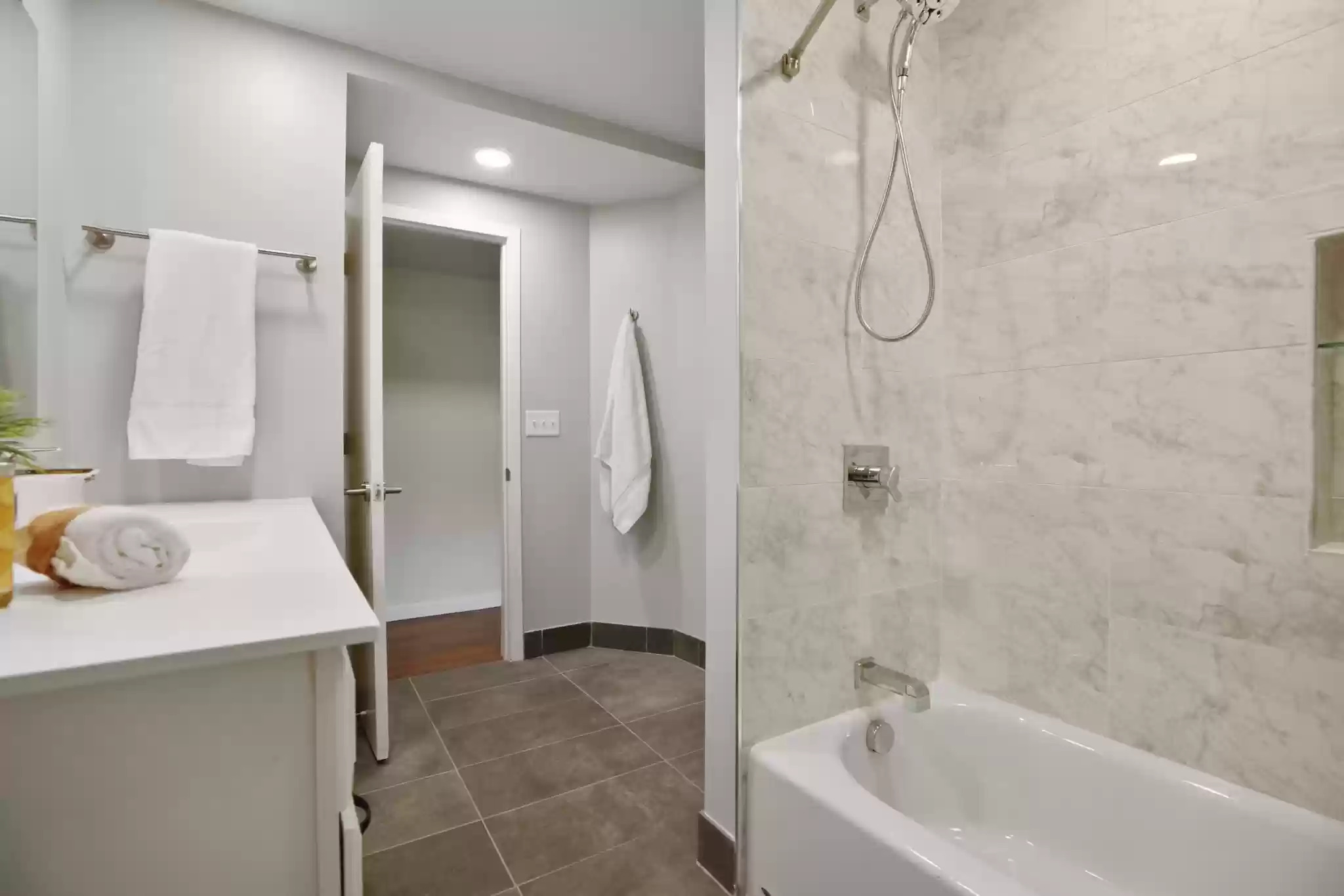 A modern and elegant bathroom with marble finishes and minimalist decor.
