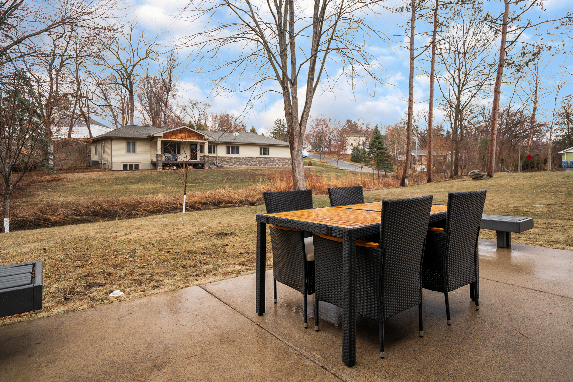A cozy outdoor dining space with a view of a serene landscape.