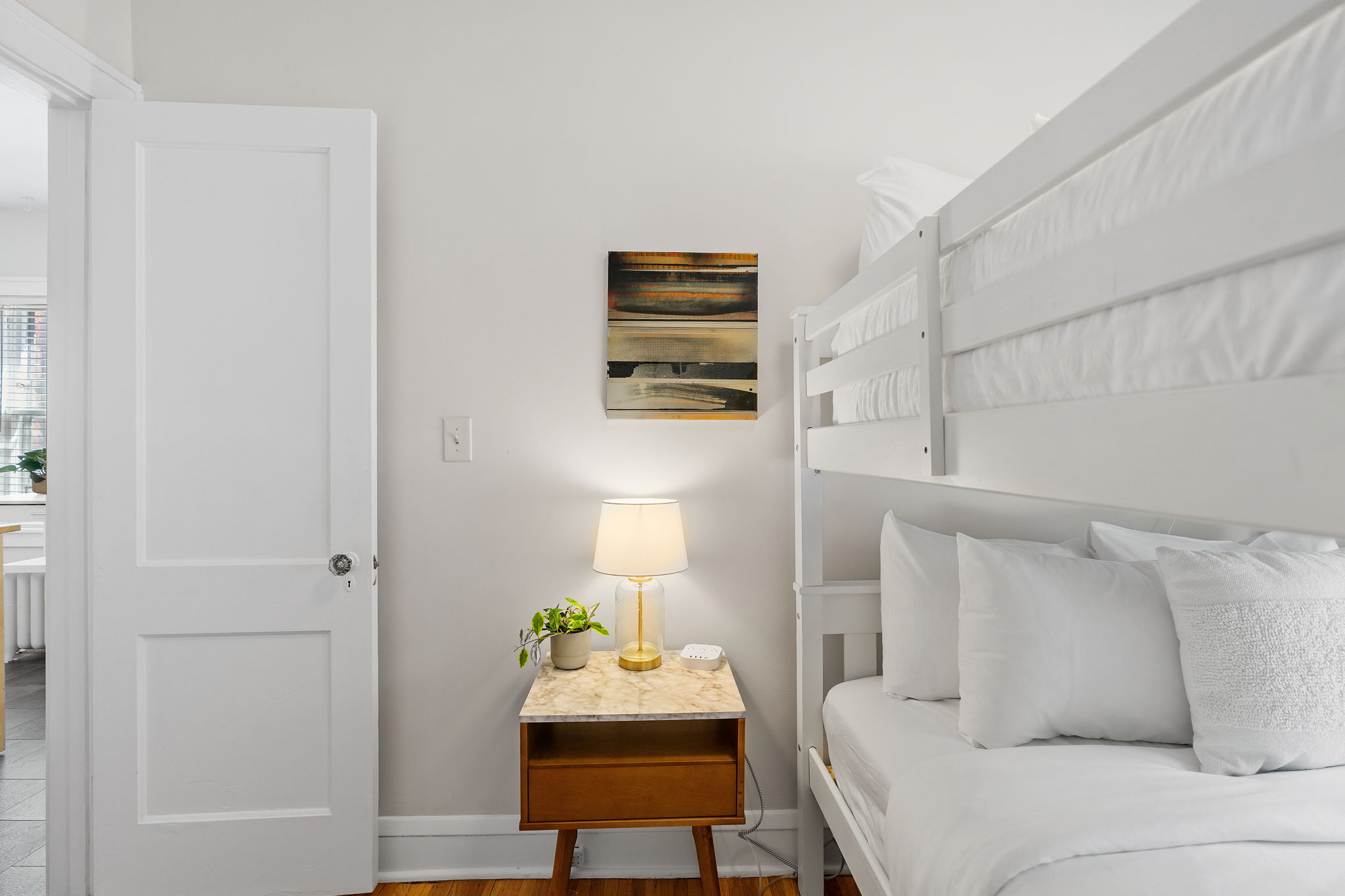 A cozy bedroom with a bunk bed and stylish decor.