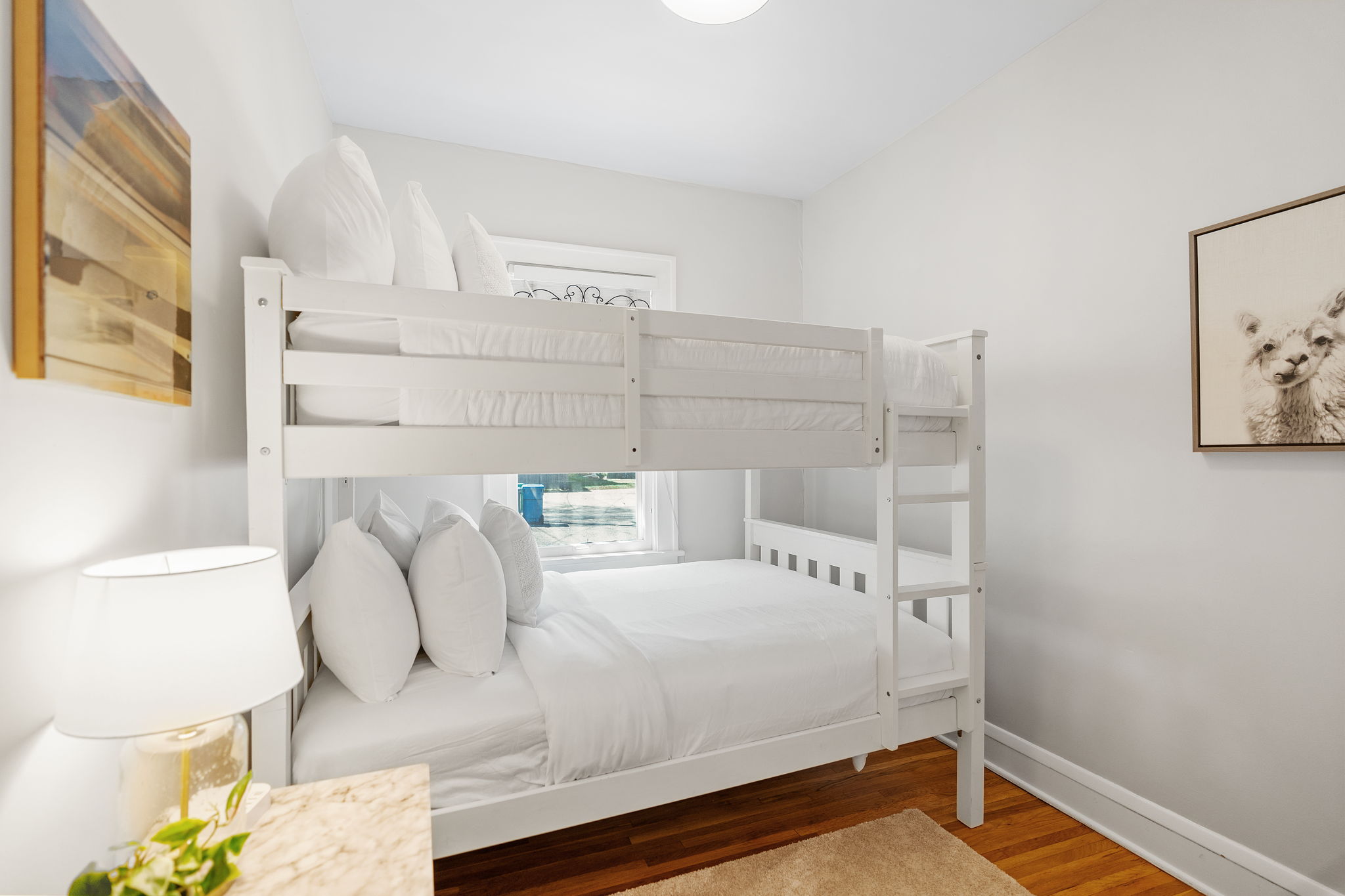 A cozy bedroom featuring a stylish bunk bed and inviting decor.