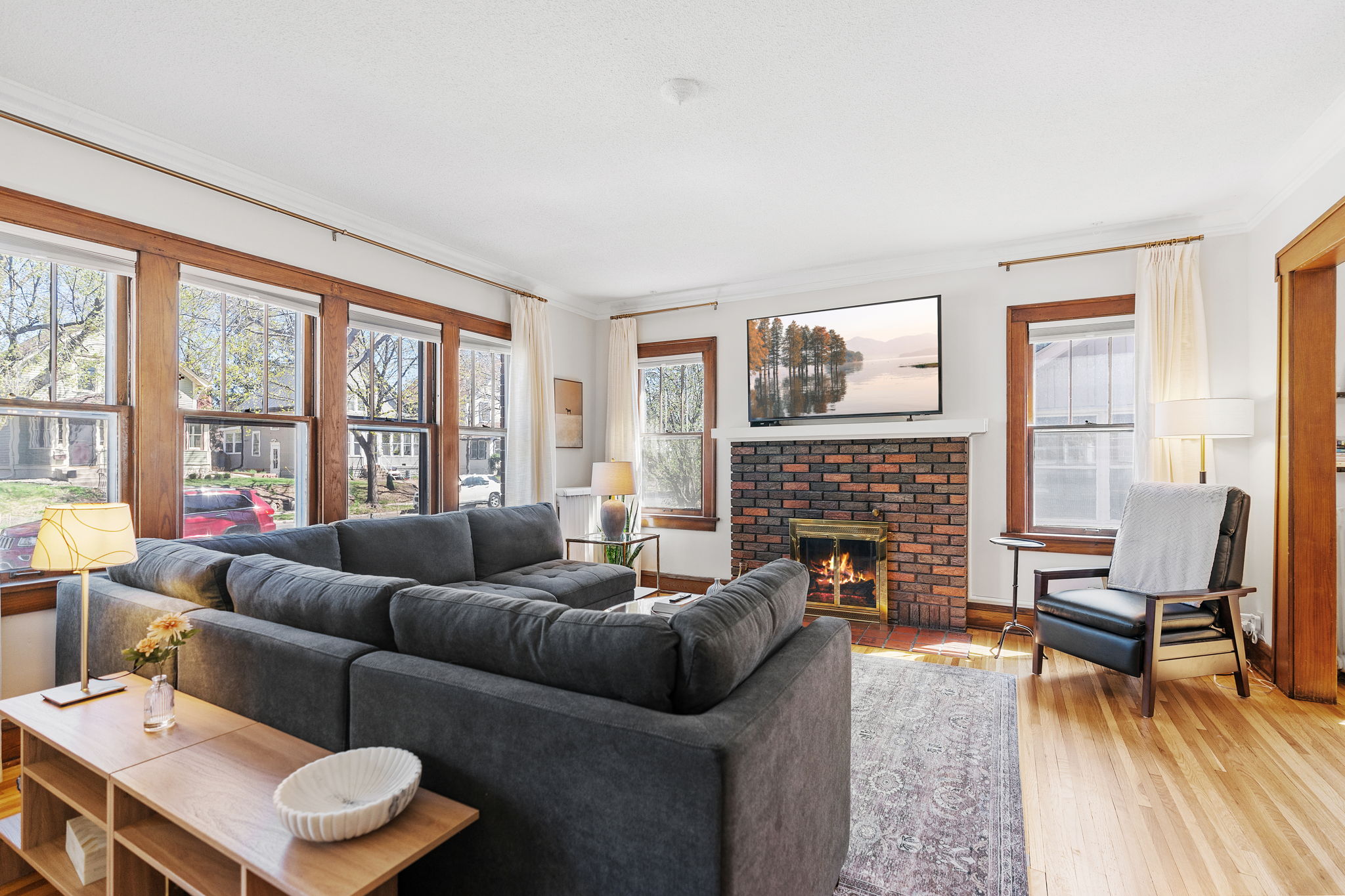 A cozy living room with a plush sectional sofa and a welcoming fireplace.