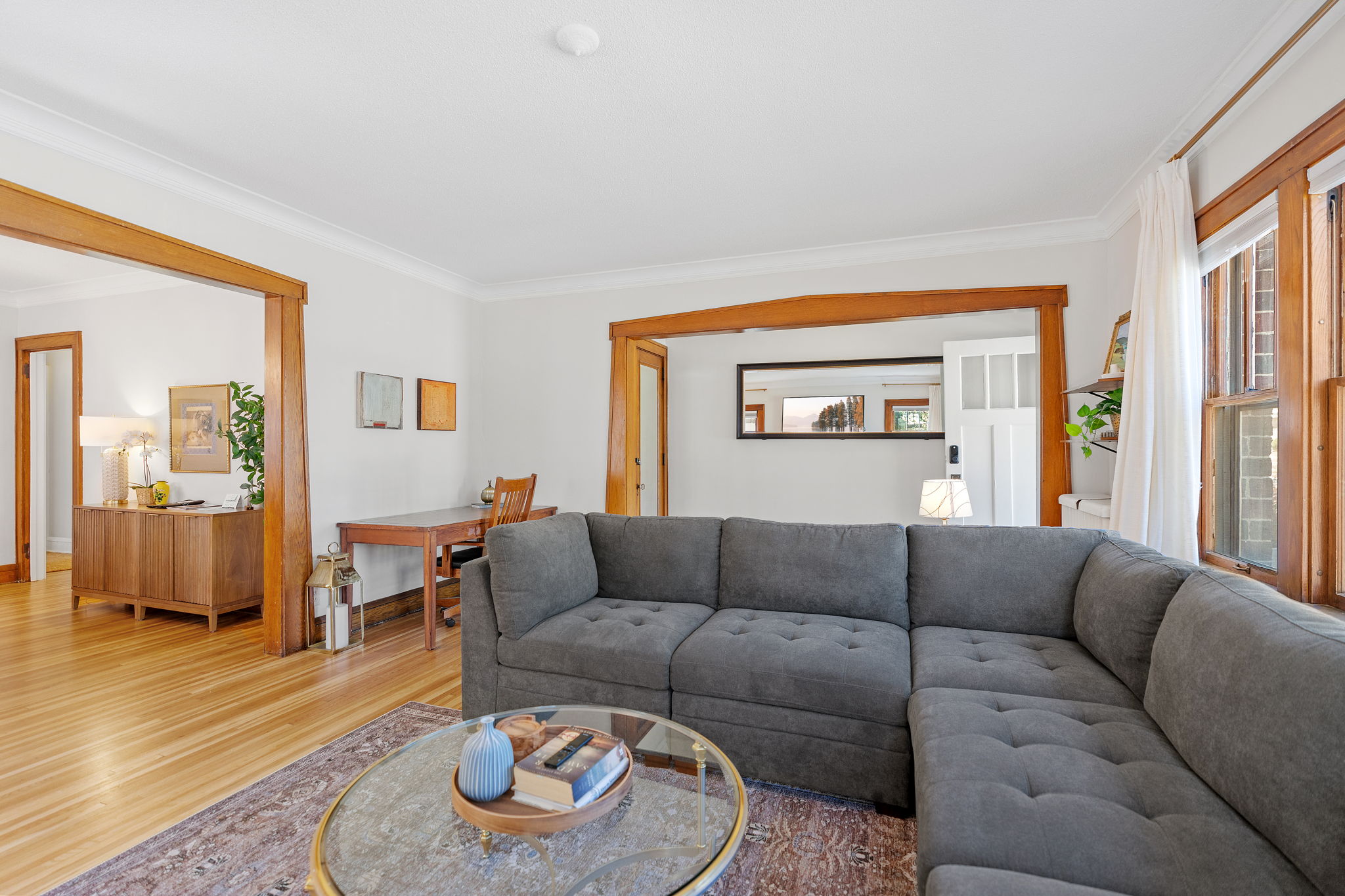 A cozy living room featuring a dark gray sectional and elegant decor.