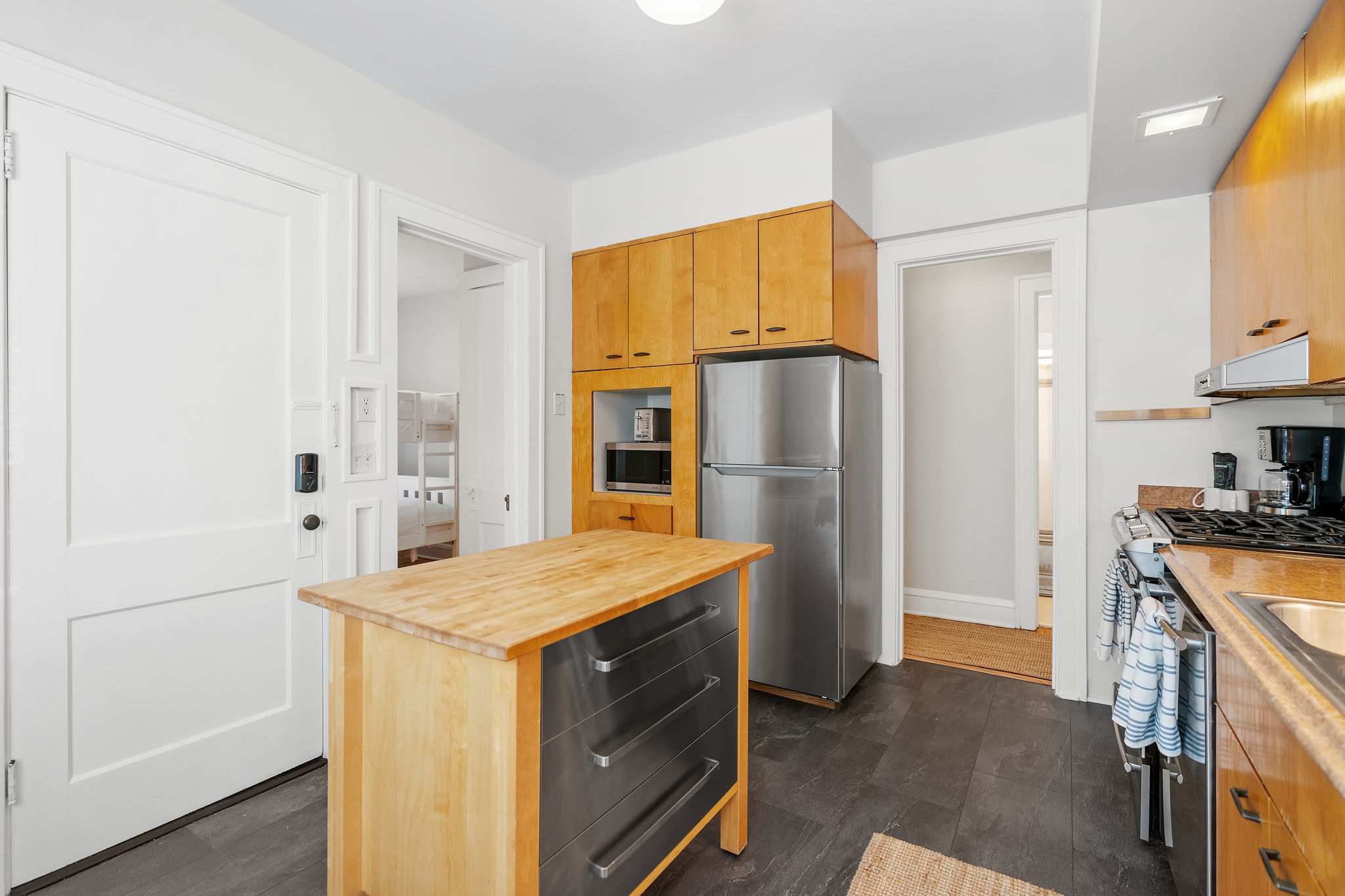 Modern kitchen featuring a central island and stainless steel appliances.