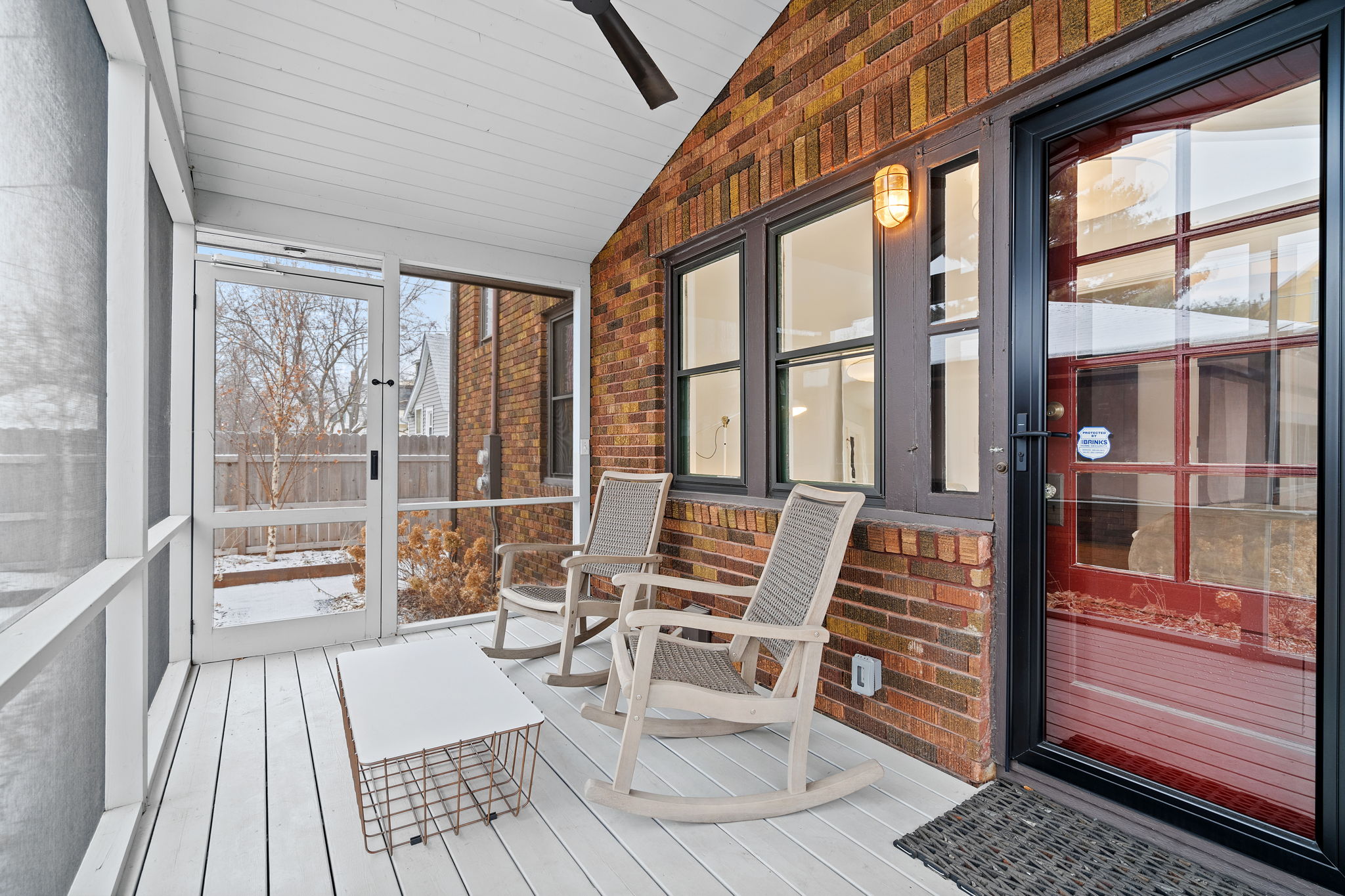 A cozy sunroom with rocking chairs and a stylish coffee table.