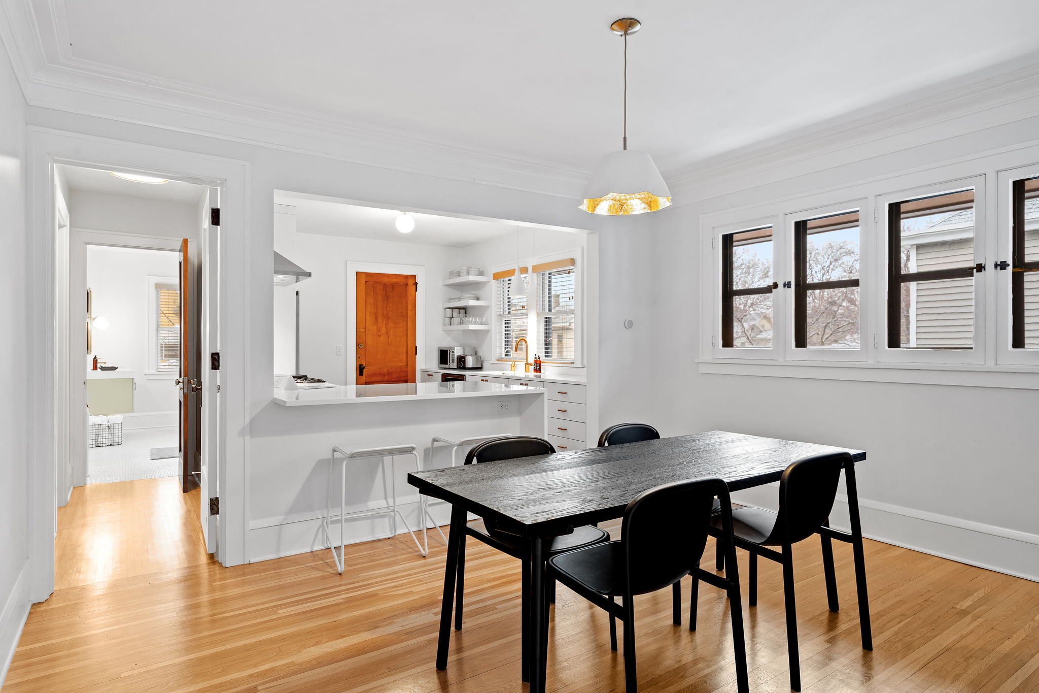 Bright and modern dining area with an open kitchen concept.