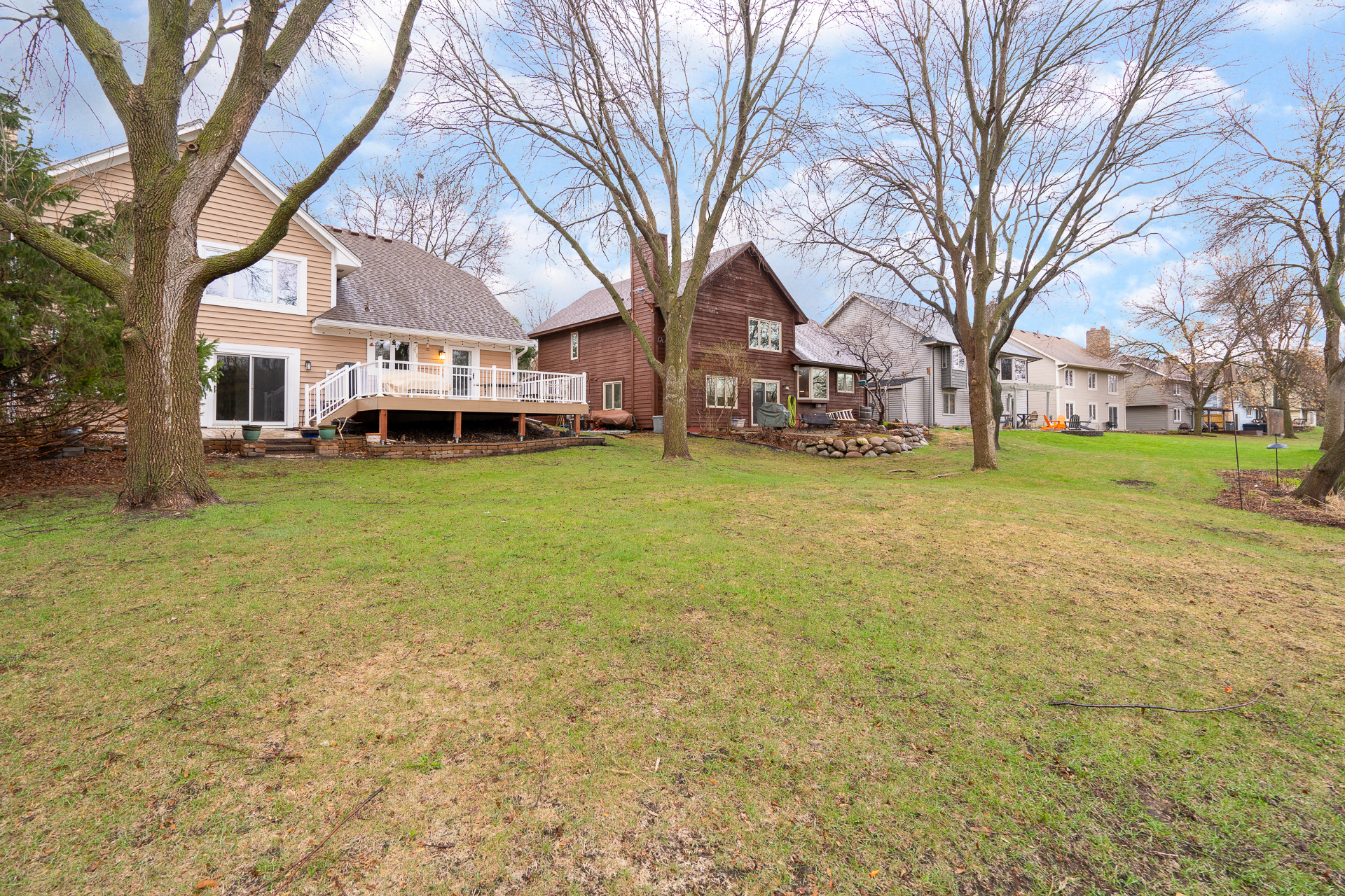 A peaceful view of three charming houses set in a lush green environment.