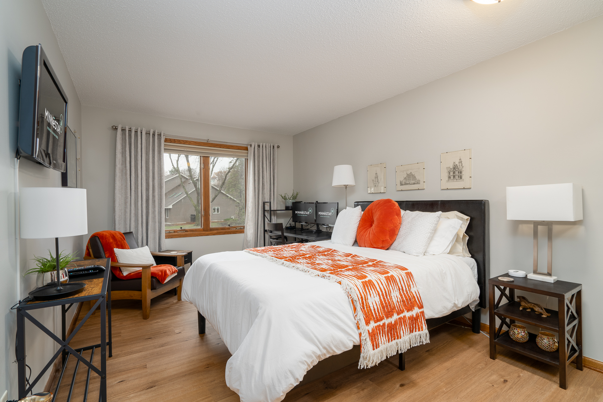 A cozy and modern bedroom with vibrant accents and a functional workspace.
