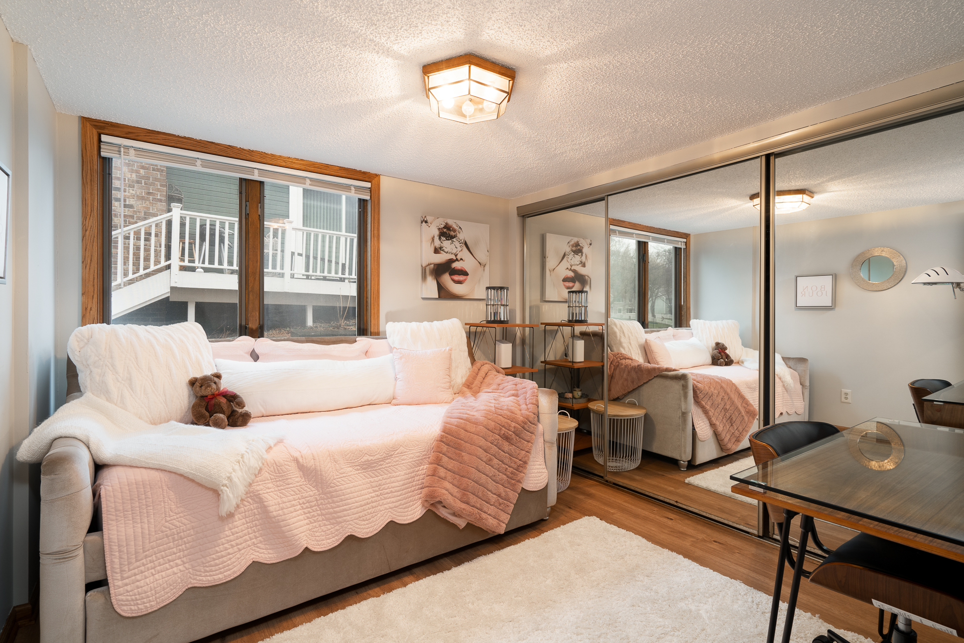 A cozy living space featuring a stylish sofa, natural light, and modern decor.