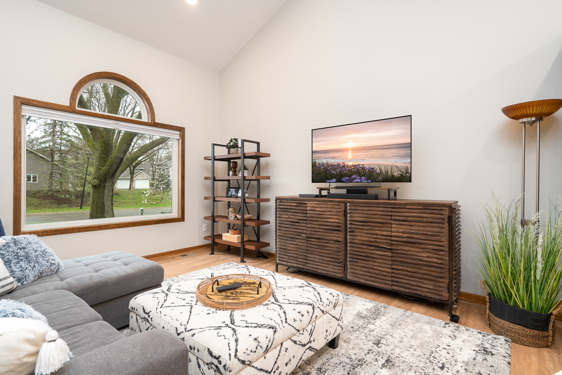 A cozy living room with modern decor and a view of nature.