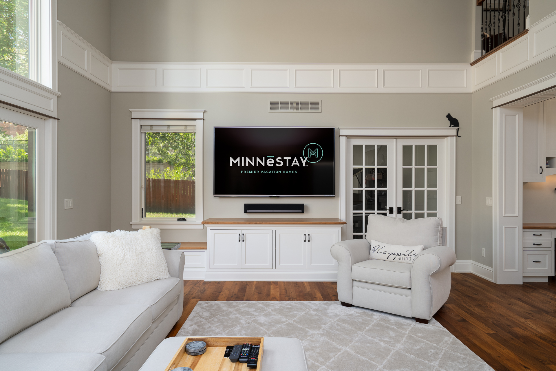 A modern living room featuring cozy furniture and a sleek television setup.