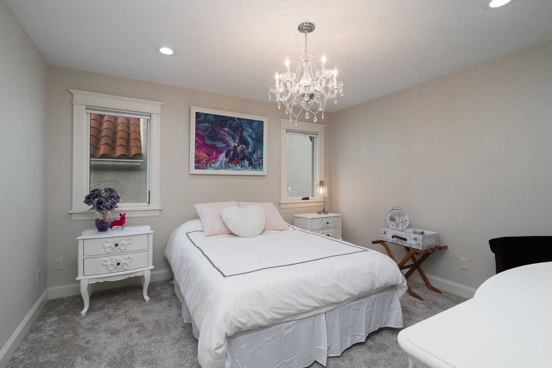 A cozy and elegantly designed bedroom with soft lighting and decorative accents.