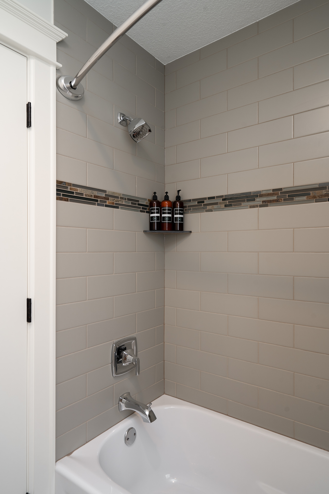 Modern bathroom corner featuring a sleek bathtub and shower.