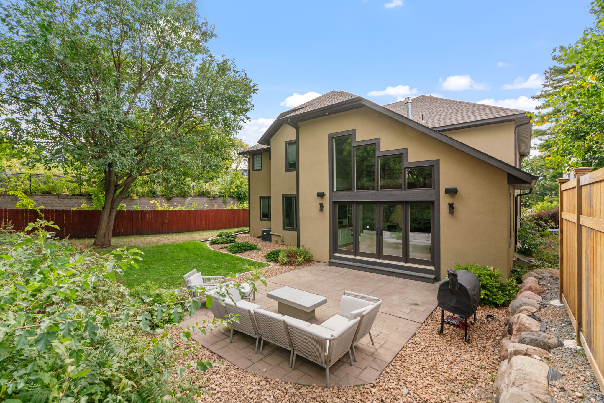 A modern home with a spacious backyard and inviting patio area.